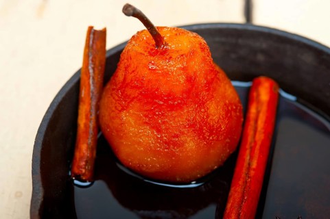Poached pears delicious home made recipe ove white rustic wood table