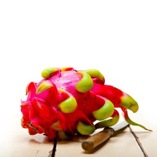 Fresh thai purple dragon fruit over white rustic table
