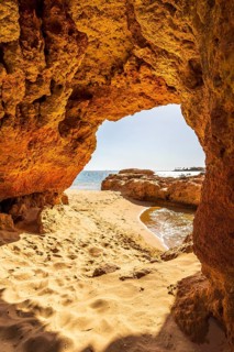 Beautiful sandstone arch with the view on marina in Portimao