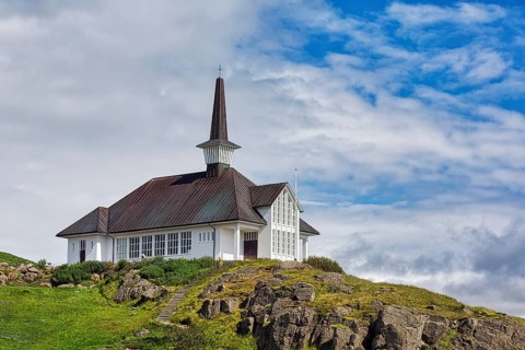 Holmavikurkirkja on hill in summer