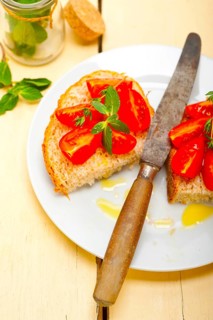 Italian tomato bruschetta with thyme and mint leaves