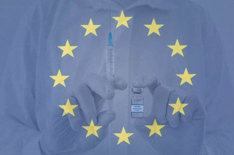 Doctor hands holding a vaccine bottle and syringe