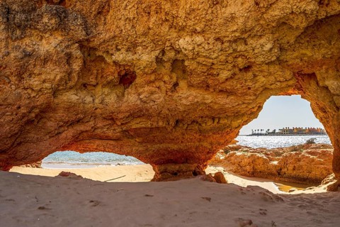 Beautiful sandstone arch with the view on marina in Portimao