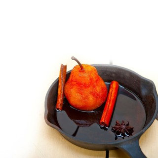 Poached pears delicious home made recipe ove white rustic wood table