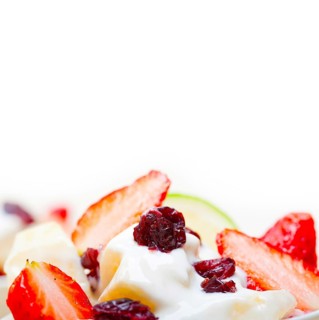 Fruit and yogurt salad healthy breakfast over white wood table