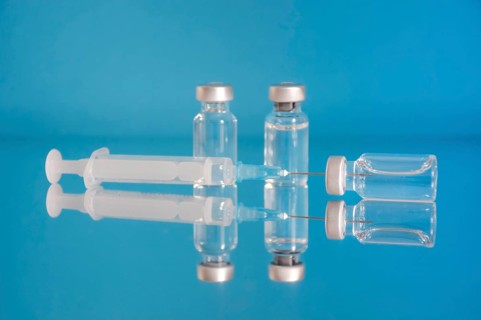 Vaccine bottles and syringe