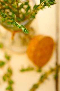 Fresh thyme on a glass jar over a white wood rustic table