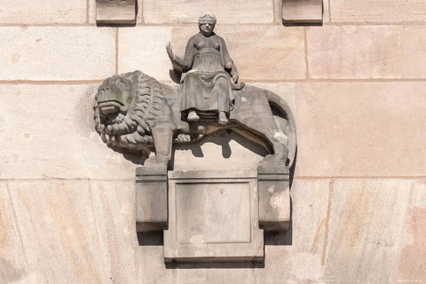 Sculpture of Justitia sitting on a lion