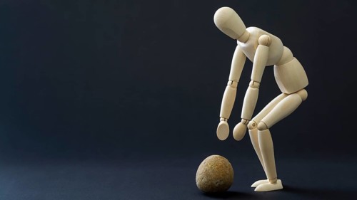 The mannequin is picking up the stone