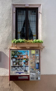 Old cigarette vending machine on the house wall