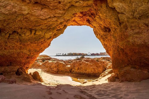 Beautiful sandstone arch with the view on marina in Portimao