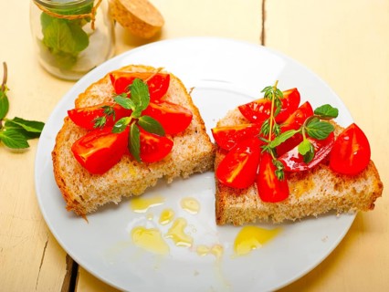Italian tomato bruschetta with thyme and mint leaves