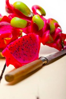 Fresh thai purple dragon fruit over white rustic table