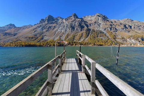 Wooden jetty on lake in autumn