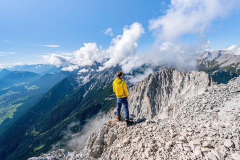 Hiker on the west summit of Hohe Munde