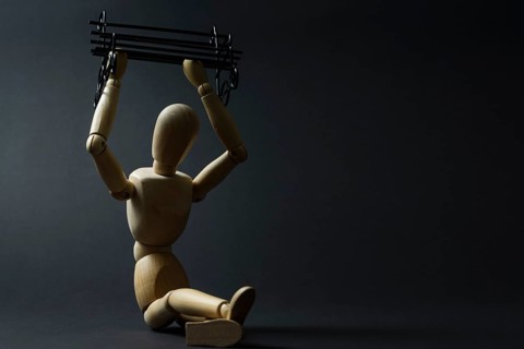The mannequin holds a bench in its hands