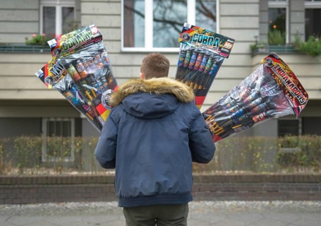 Man with many New Year's Eve rockets