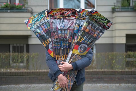 Man with many New Year's Eve rockets