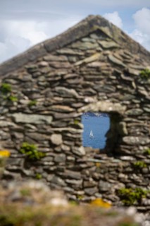 Decaying gable end and window of former village house on Great Blasket Island with view of Blasket Sound. County Kerry