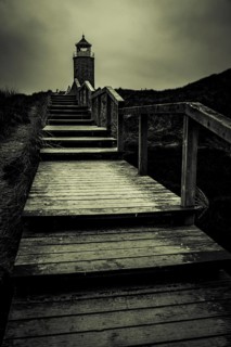 Cross light red cliff with wooden stairs