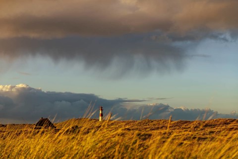 Dune landscape with storm clouds and List-ost lighthouse