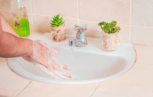 Close up of a person washing their hands with soap
