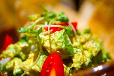 Fresh avocado and shrimps salad with nachos on side