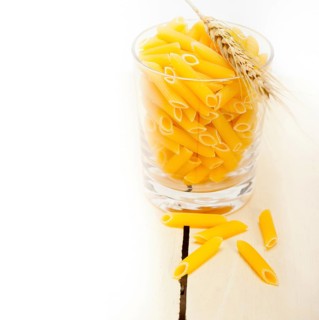 Short Italian pasta penne with durum wheat grains