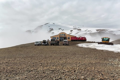Four-wheel drive vehicles on car park in front of mountain hotel Joeklasel in summer