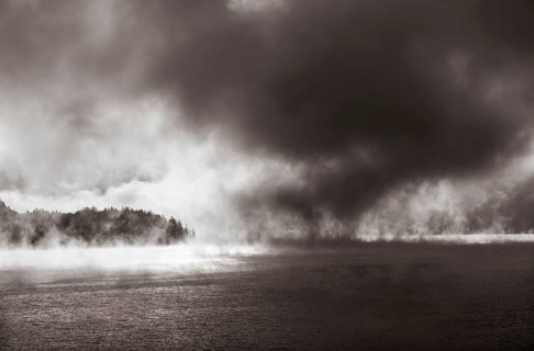 Sun penetrates through the morning mist at Lake Wolfgang