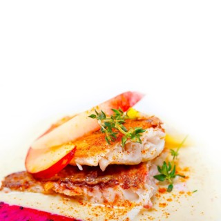 Sea bream orata fillet butter pan fried with fresh peach prune and dragonfruit slices thyme on top