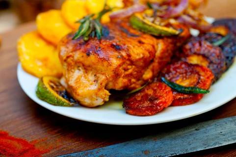 Roasted grilled BBQ chicken breast with herbs and spices rustic style