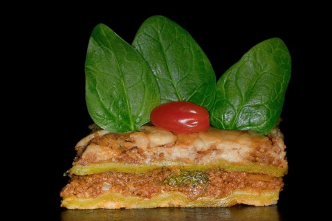 Classic lasagne with spinach leaves and tomato