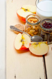 Healthy breakfast ingredients milk oat cashew nuts dried cramberry craisinns