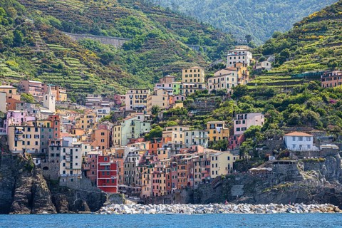 The village of Riomaggiore with its nested pastel-coloured houses built into the hillside