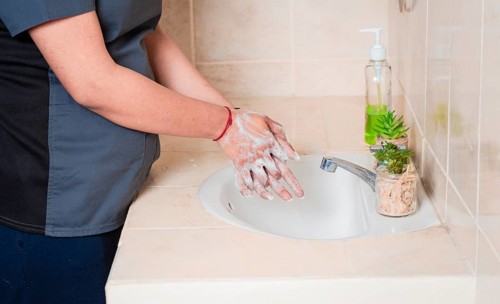 Close up of a person washing their hands with soap