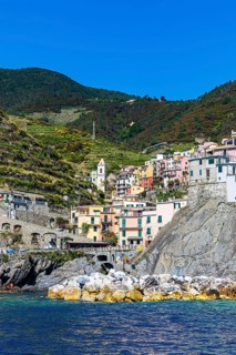 The village of Manarola with its nested pastel-coloured houses built into the hillside
