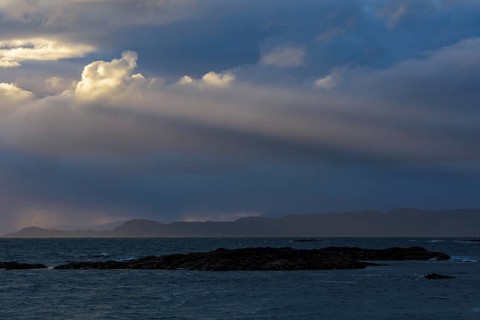 Scottish coast at sunset with sunrays