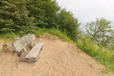 Bench on steep coast at sunrise