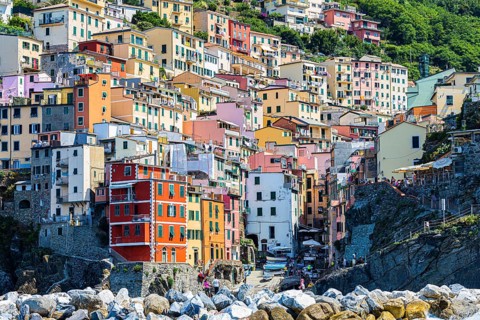 The village of Riomaggiore with its nested pastel-coloured houses built into the hillside