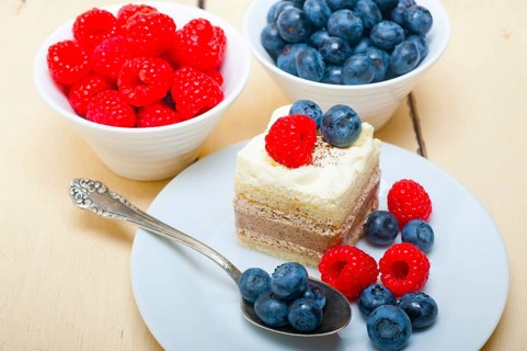 Fresh homemade raspberry and blueberry cream cake