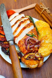 Roasted grilled BBQ chicken breast with herbs and spices rustic style