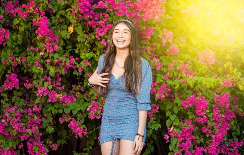 Portrait of a cute latin american girl smiling in a garden
