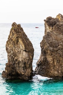 Boulders in the turquoise green sea