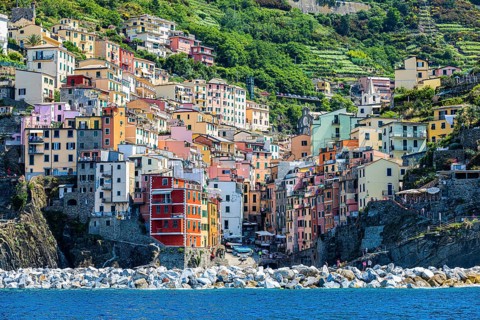 The village of Riomaggiore with its nested pastel-coloured houses built into the hillside