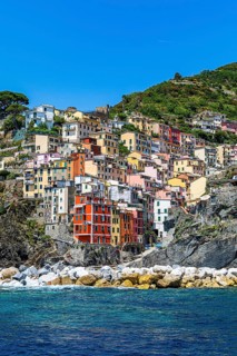 The village of Riomaggiore with its nested pastel-coloured houses built into the hillside