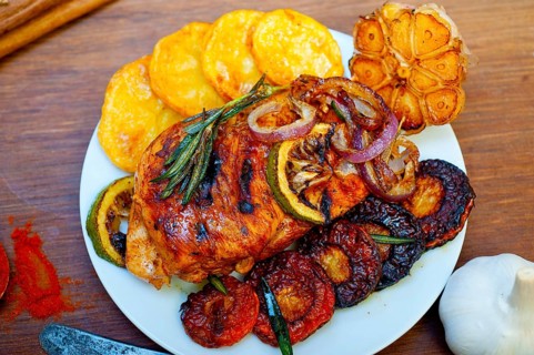 Roasted grilled BBQ chicken breast with herbs and spices rustic style