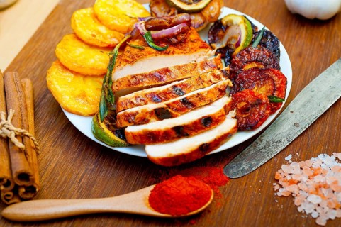 Roasted grilled BBQ chicken breast with herbs and spices rustic style