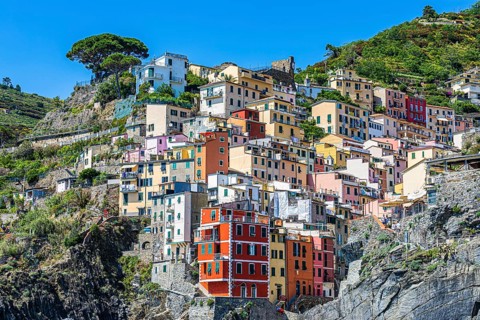 The village of Riomaggiore with its nested pastel-coloured houses built into the hillside