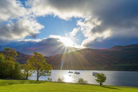 Lake with dramatic clouds and sun in spring